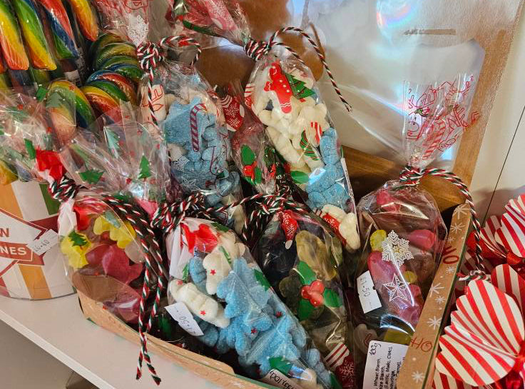 Assorted candy and toys in a box on a shelf